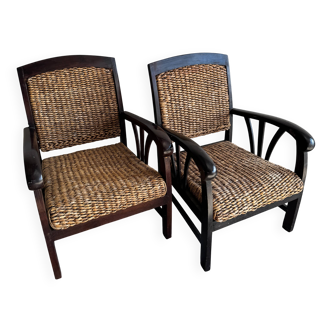 Set of two colonial dark-brown wooden armchairs with natural rattan seating (pair)