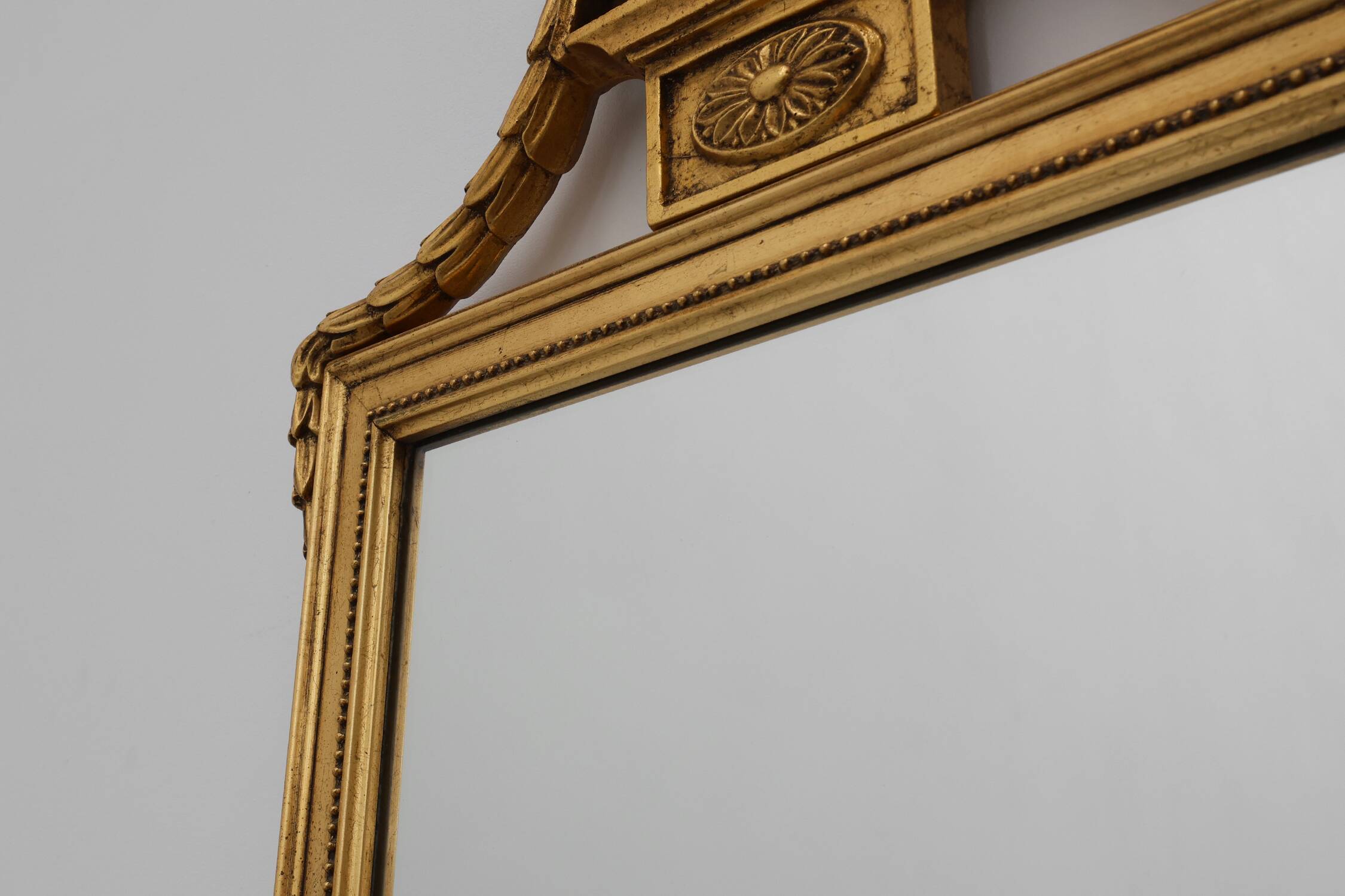 20th Century gilded wooden Empire style mirror with eagle on top
