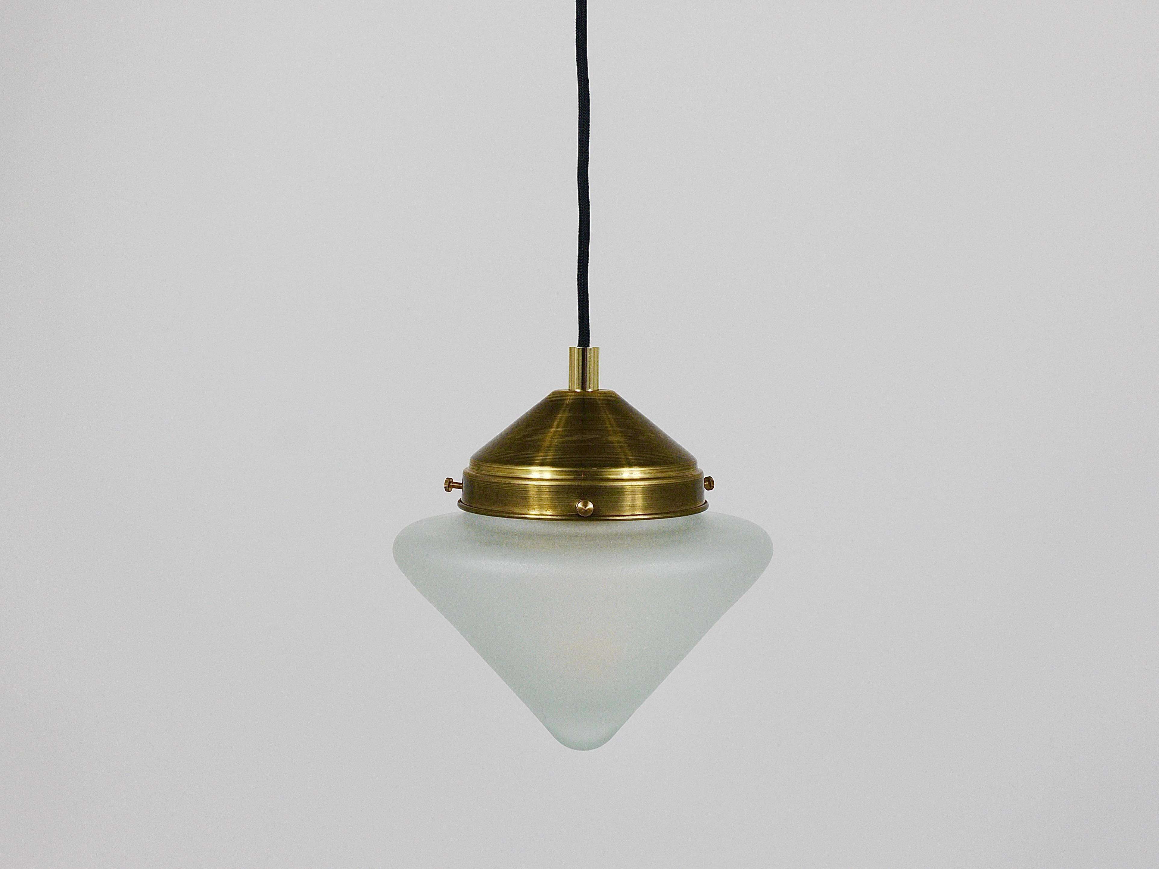 Up to 7 Art Deco brass pendant lights with conical glass shades, Vienna 1930s.