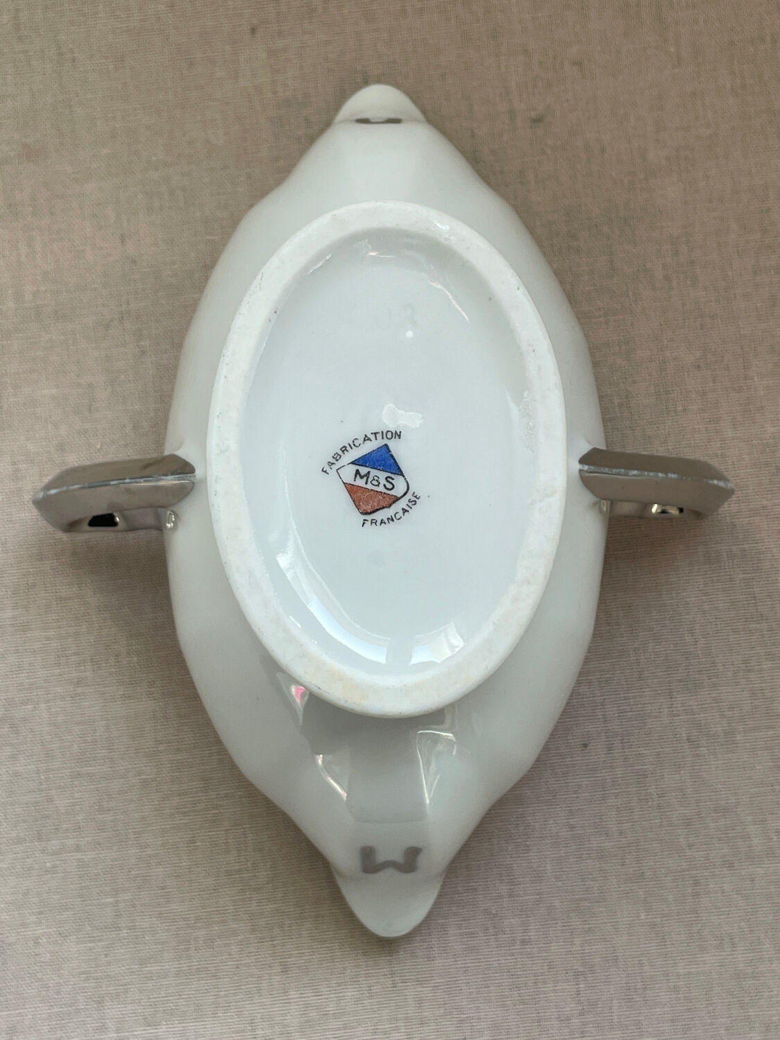 Antique white French porcelain sauce boat M&S with silver trim.