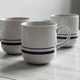 White ceramic cups with blue borders.