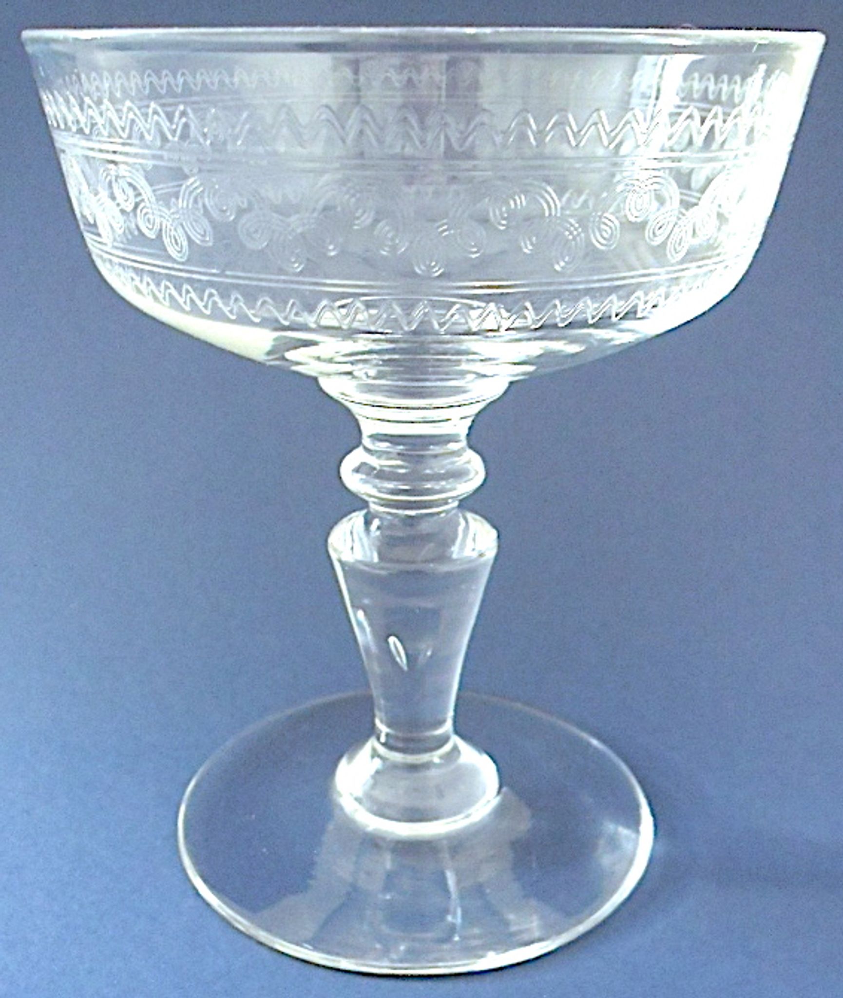 Suite of six champagne glasses on foot in engraved colorless crystal