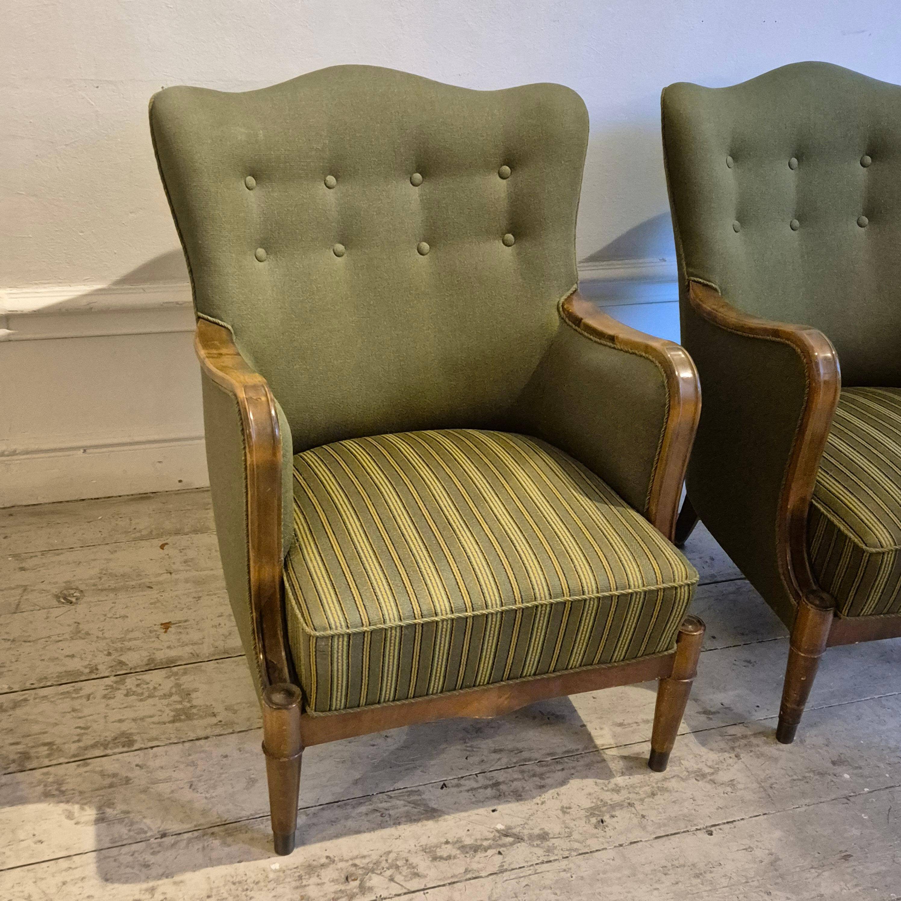 Modern Danish armchairs by Alfred Christensen. Beautiful shape, brass legs.