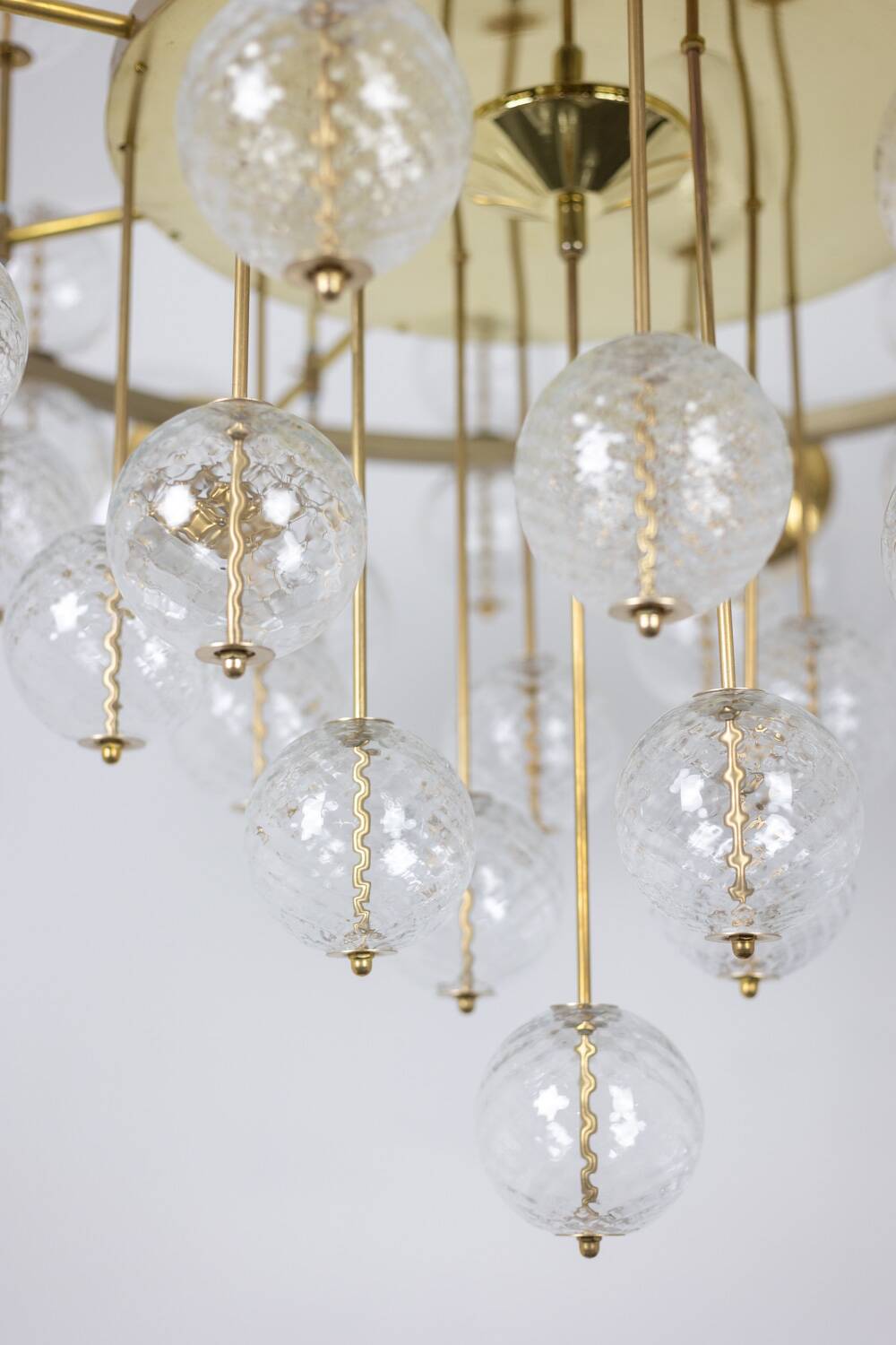 Large chandelier in gilded brass with decorative balls. 1970s.