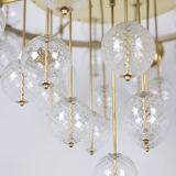 Large chandelier in gilded brass with decorative balls. 1970s.