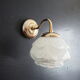 Brass wall lamp and white glass globe from the 1950s-1960s.