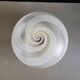 Frosted glass globe ceiling light with spiral patterns.