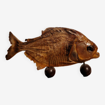 Stuffed piranha on wooden stand