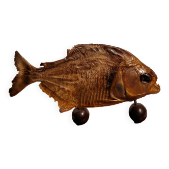 Stuffed piranha on wooden stand