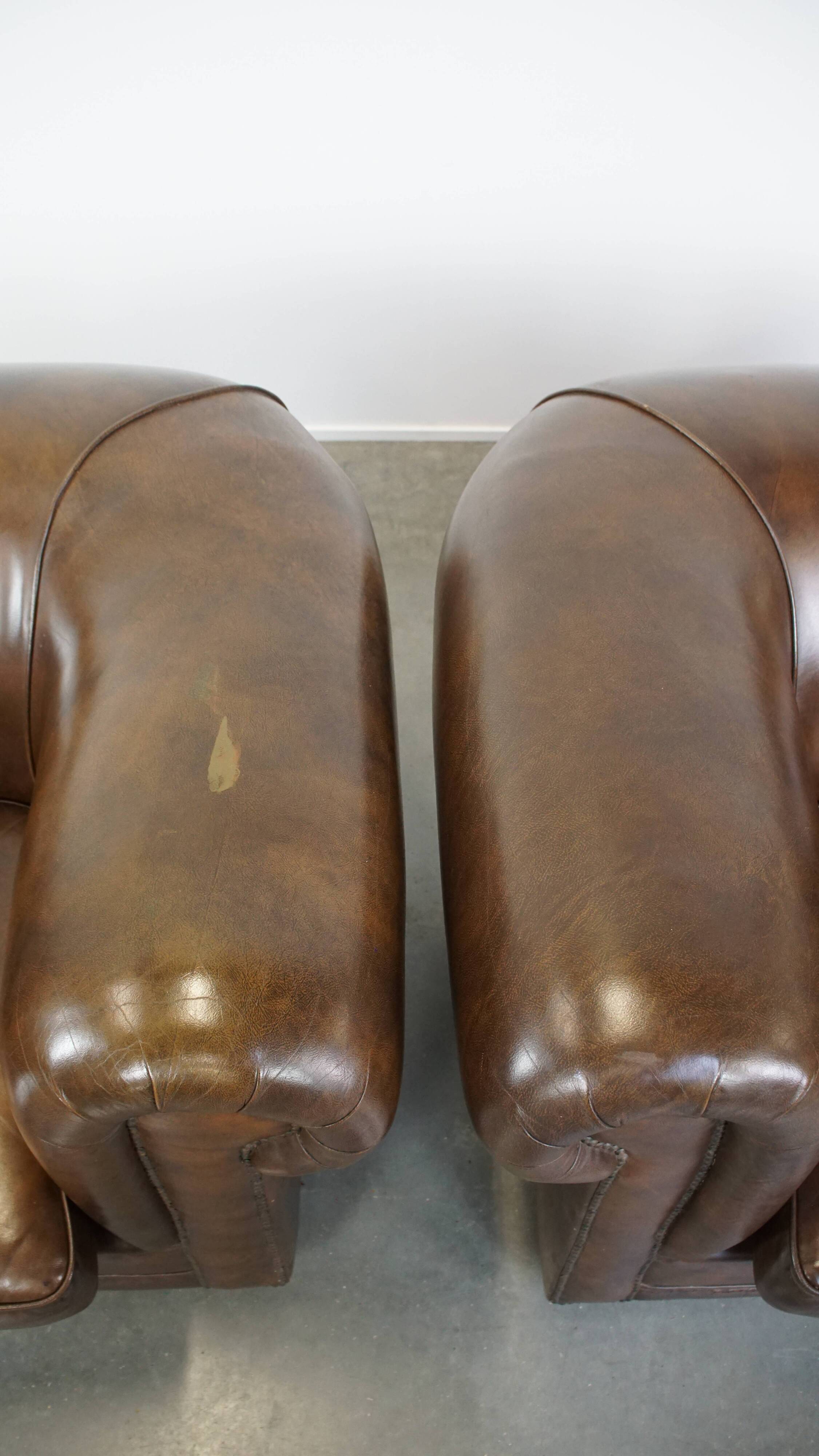 2 Chesterfield armchairs in dark brown cowhide