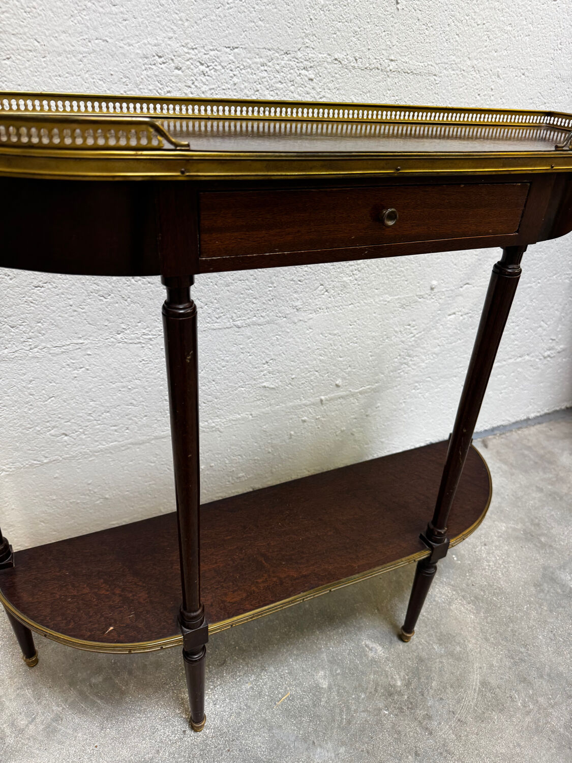 Louis XVI demi-moon console in wood and brass.