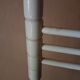 Bath towel rack in white wood, three bars.