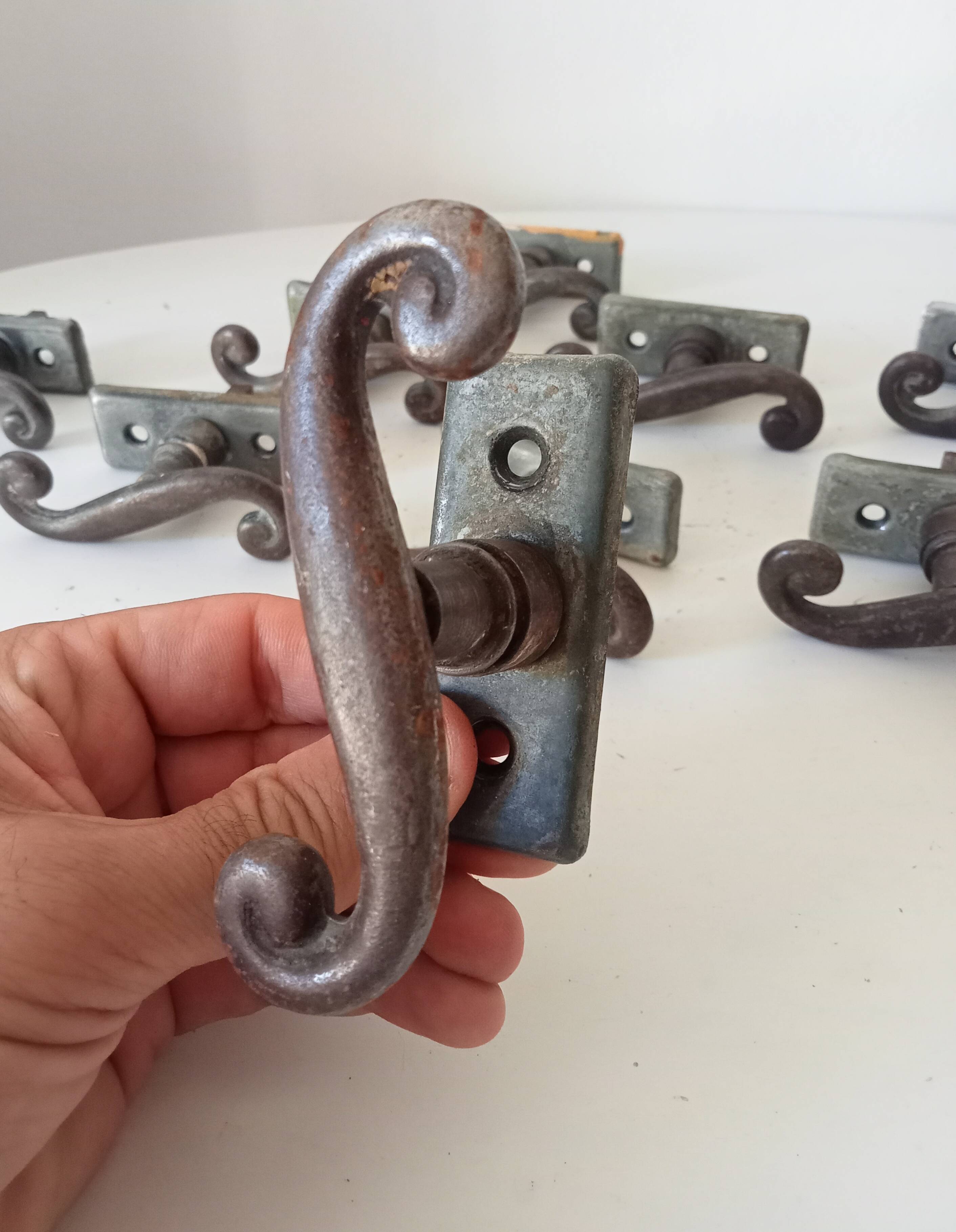 Old window handle with a forged iron cremon.
