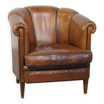 Unique vintage cognac-coloured leather club armchair with black piping
