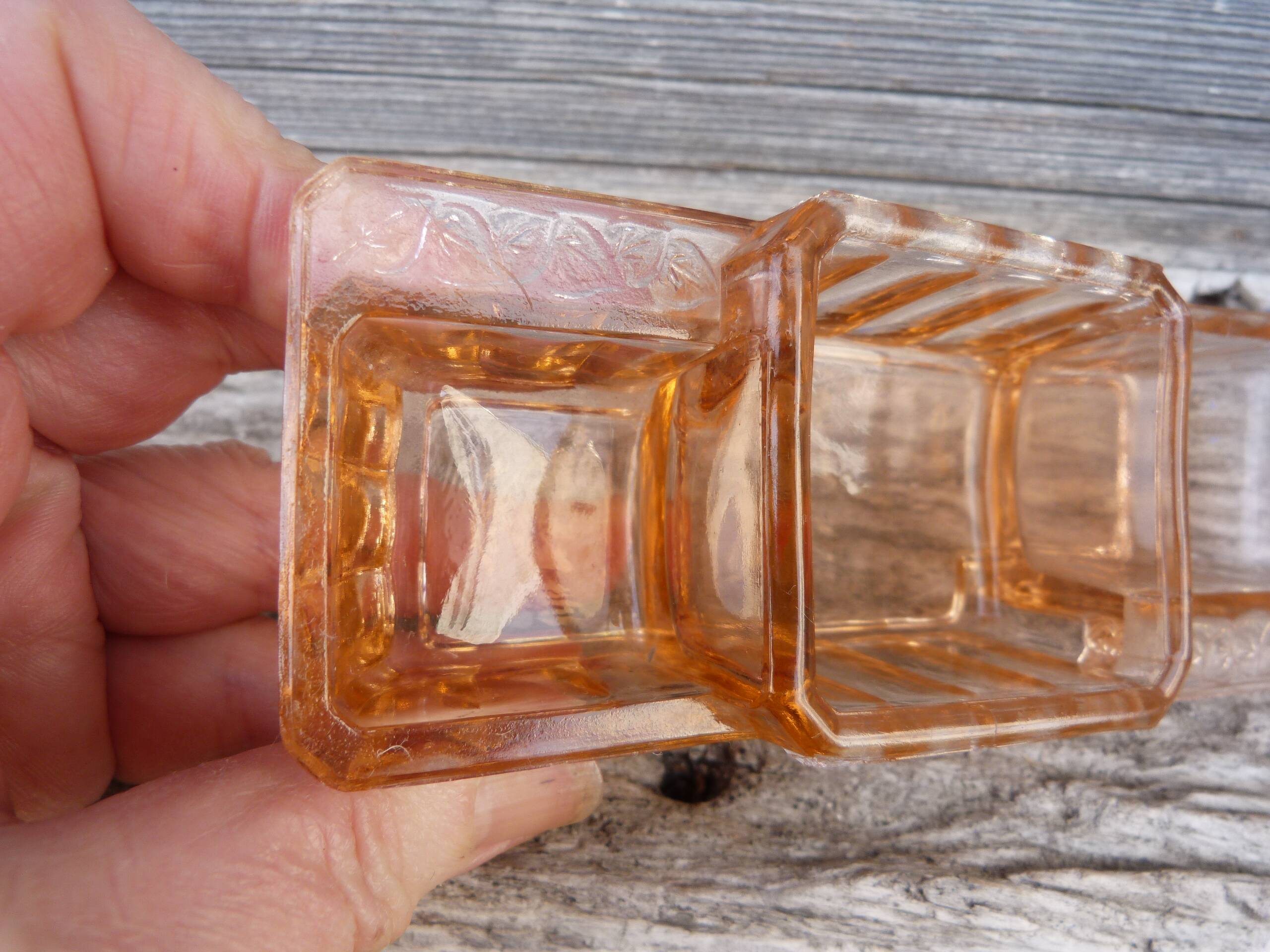 Glass condiment service in transparent pink moulded glass.