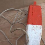 Old red and white wooden buoy