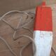 Old red and white wooden buoy