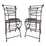 Series of four designer cast iron chairs with reversed backs and very beautiful x-legs