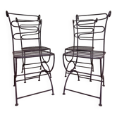 Series of four designer cast iron chairs with reversed backs and very beautiful x-legs