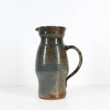 Handcrafted stoneware pitcher with blue-green hues, signed piece