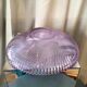 Twisted glass fruit cup of purplish pink color