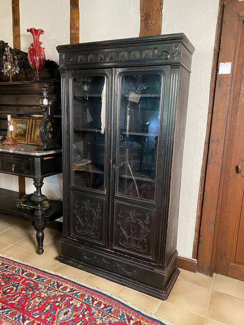Blackened wooden display cabinet from the late 19th or early 20th century.