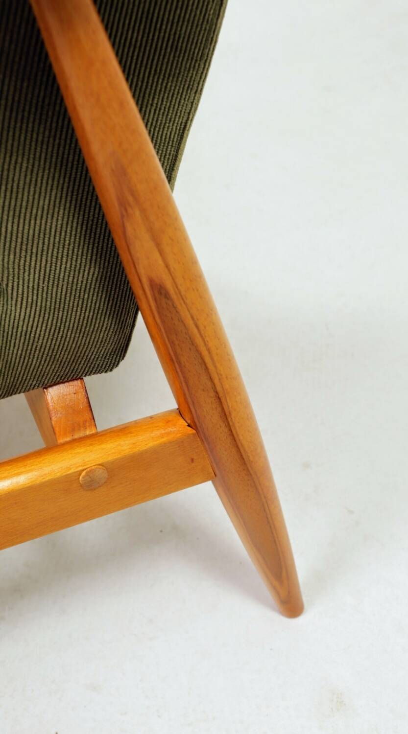 Mid-century modern design armchair in olive green corduroy.