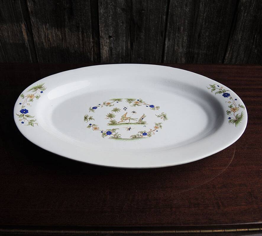 Old large oval serving dish in Moustiers earthenware.