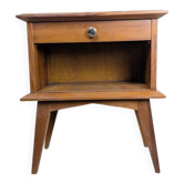 Vintage bedside table with tapered legs.