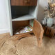 Pair of mismatched art deco bedside tables in green and wood