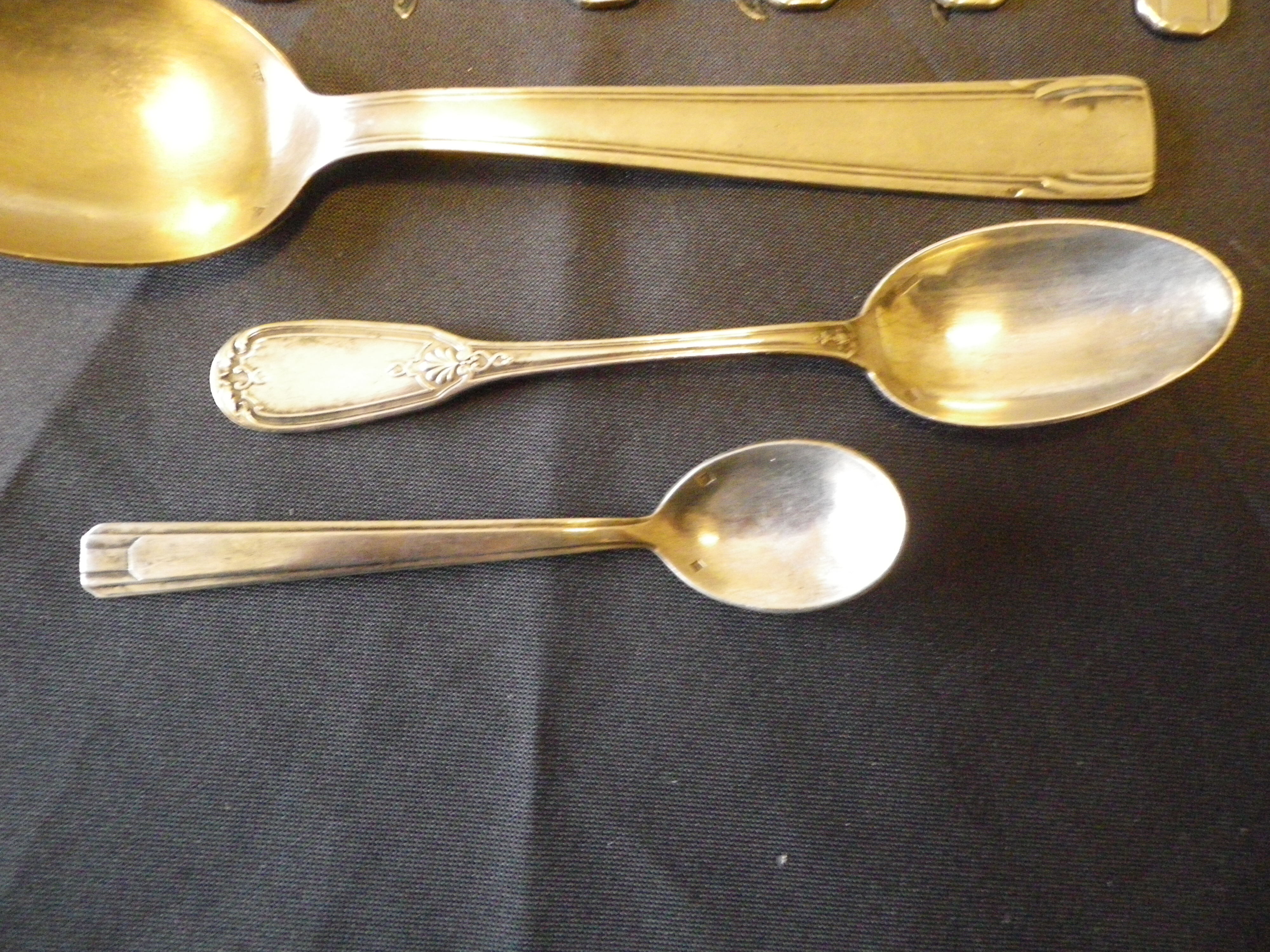 11 silver spoons with punches