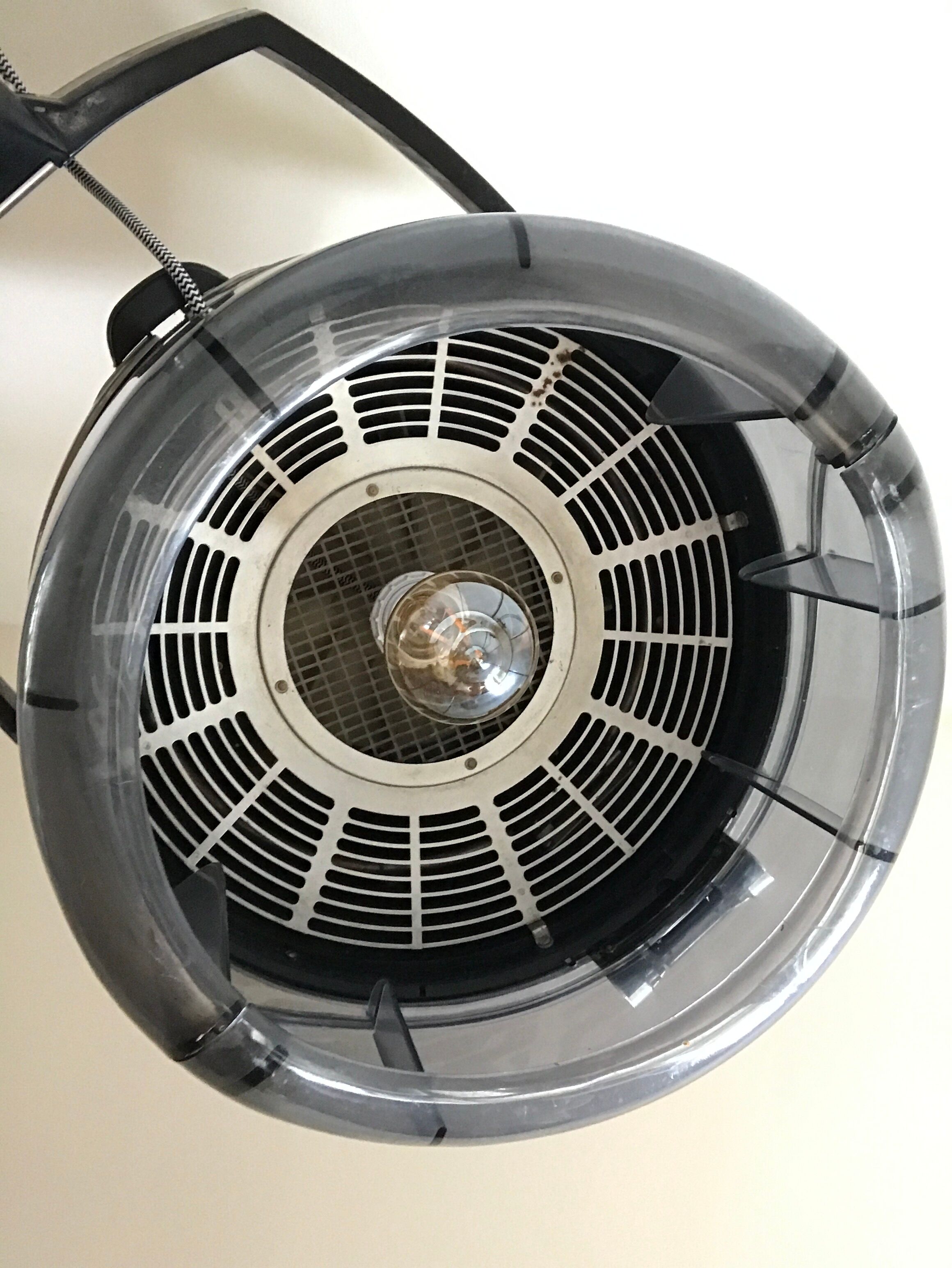 Vintage hairdresser's armchair with helmet transformed into a lamp