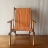 Old foldable beach seat in wood and canvas for children