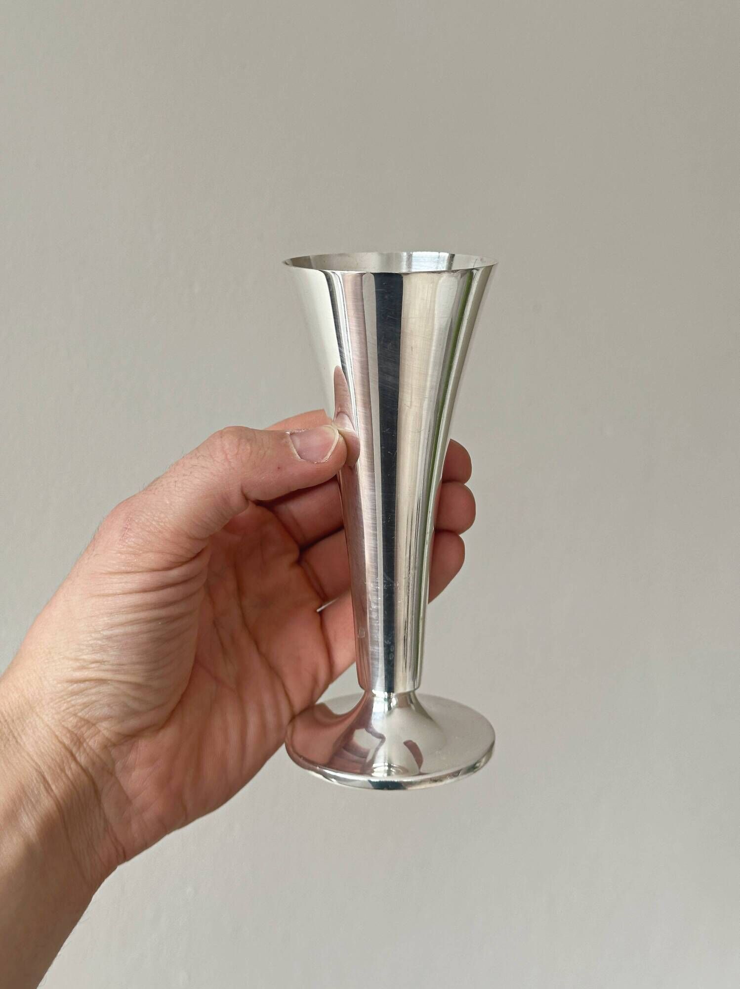 Two silver-coloured lightweight metal flower vases.