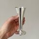 Two silver-coloured lightweight metal flower vases.