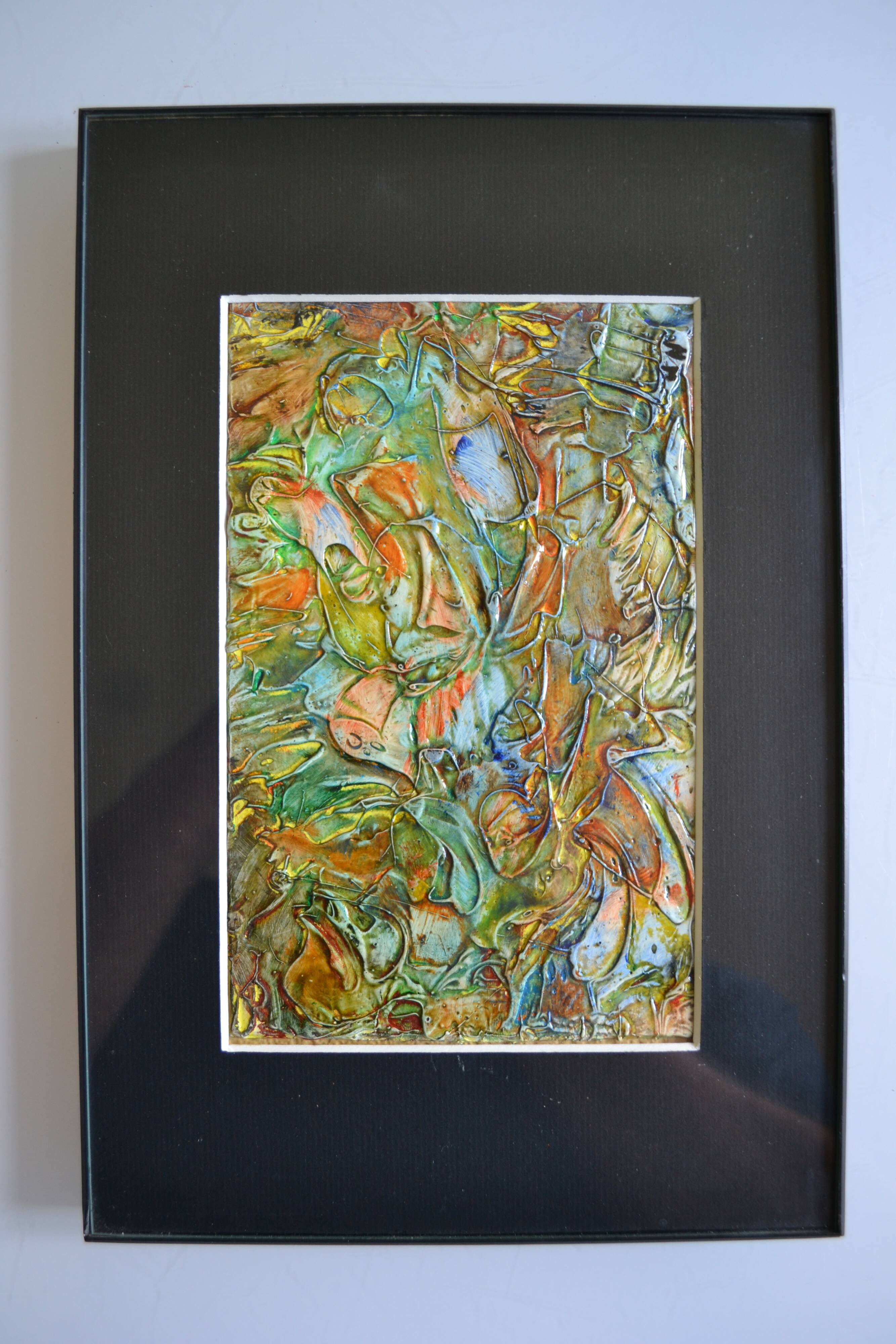 Framed abstract painting under glass