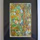 Framed abstract painting under glass