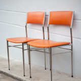 Pair of chrome metal chair and orange skai