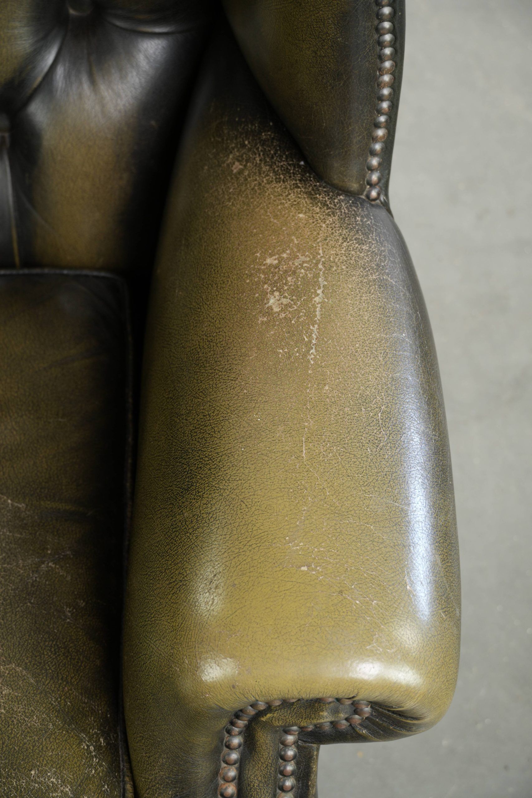 Vintage cowhide leather Chesterfield wingback armchair in a green colour