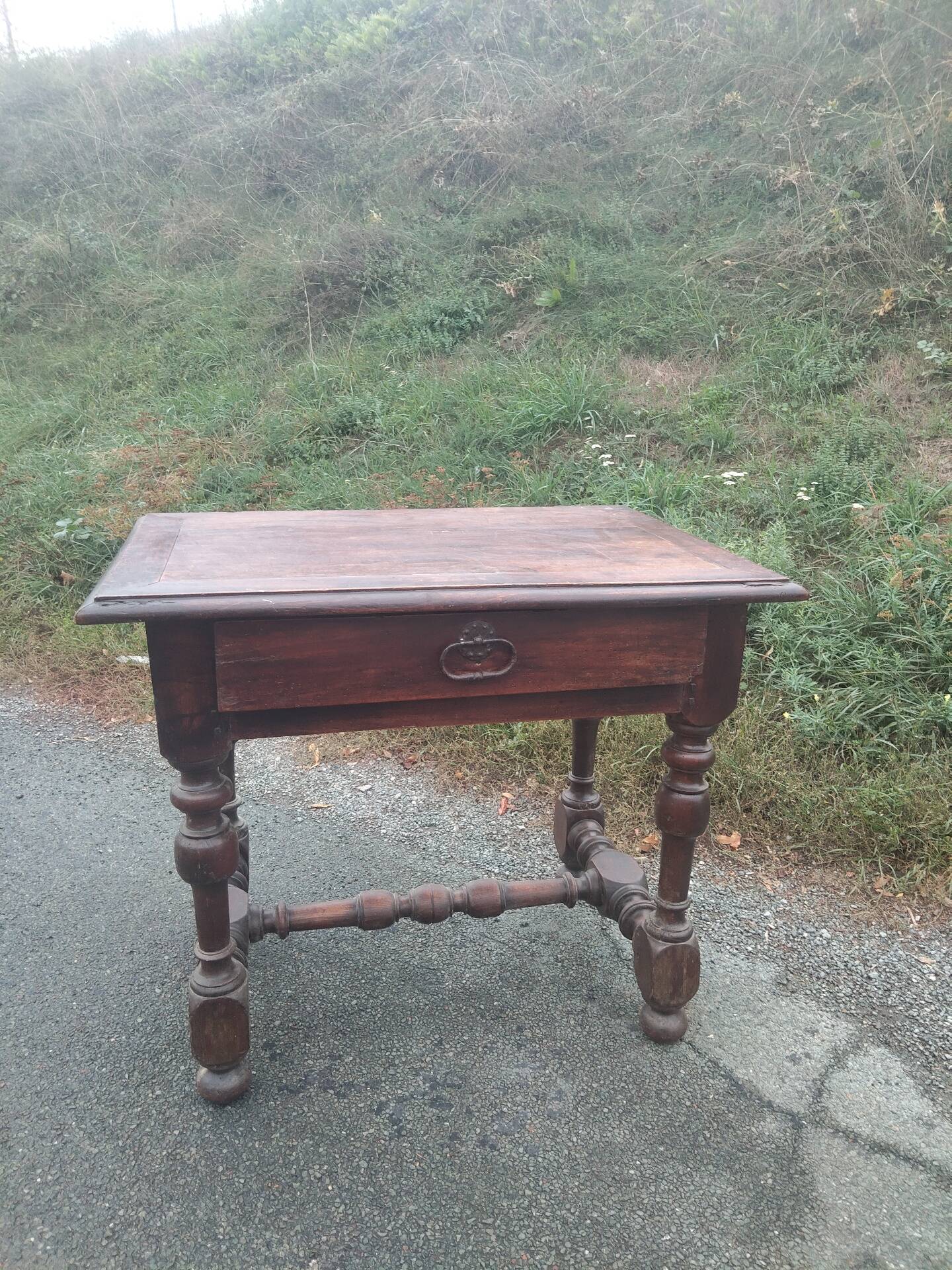 Small antique writing table in Louis XIII style made of oak.