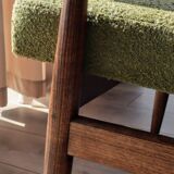 Mid-century modern armchair in olive green bouclé design by H. Lis.