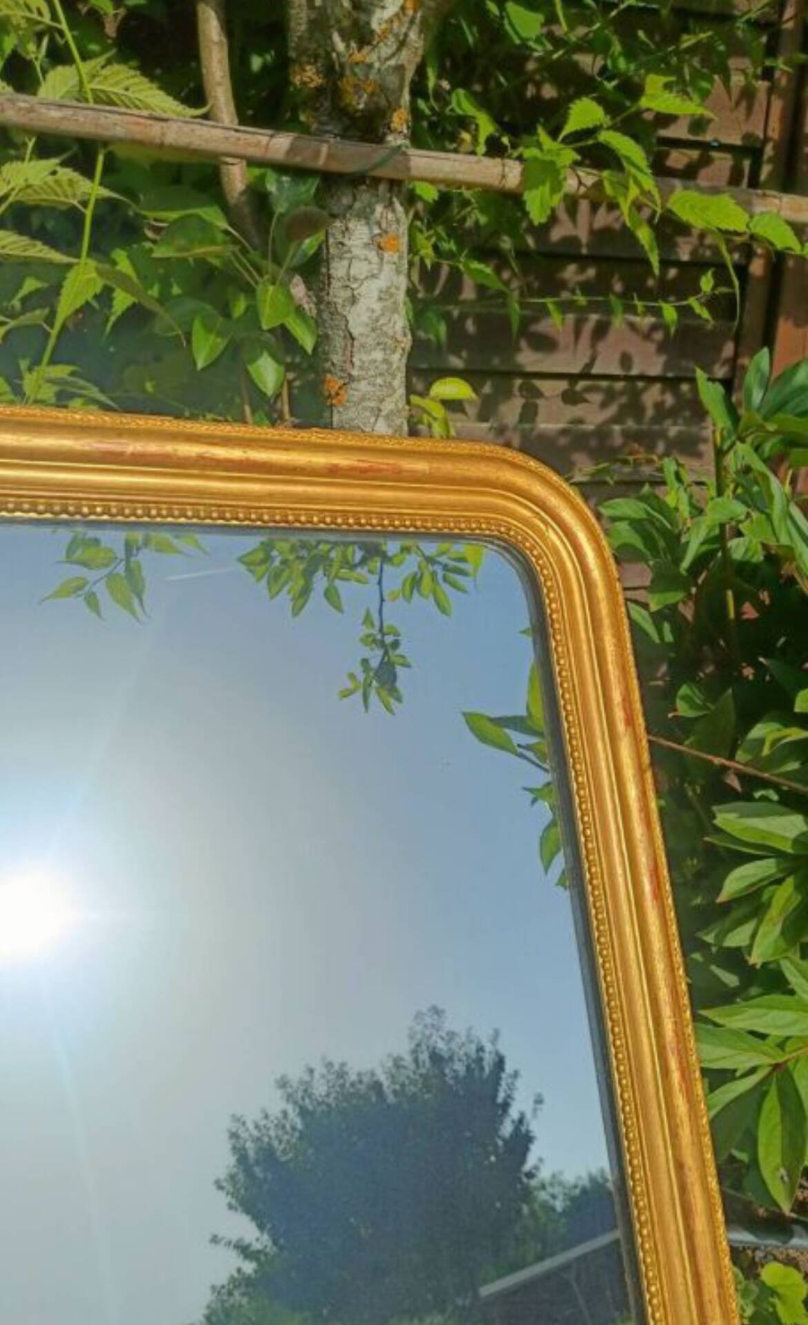 Antique Louis-Philippe mirror, gilded and patinated.