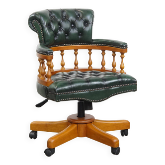 Green classic chesterfield office chair made of cowhide leather on wheels