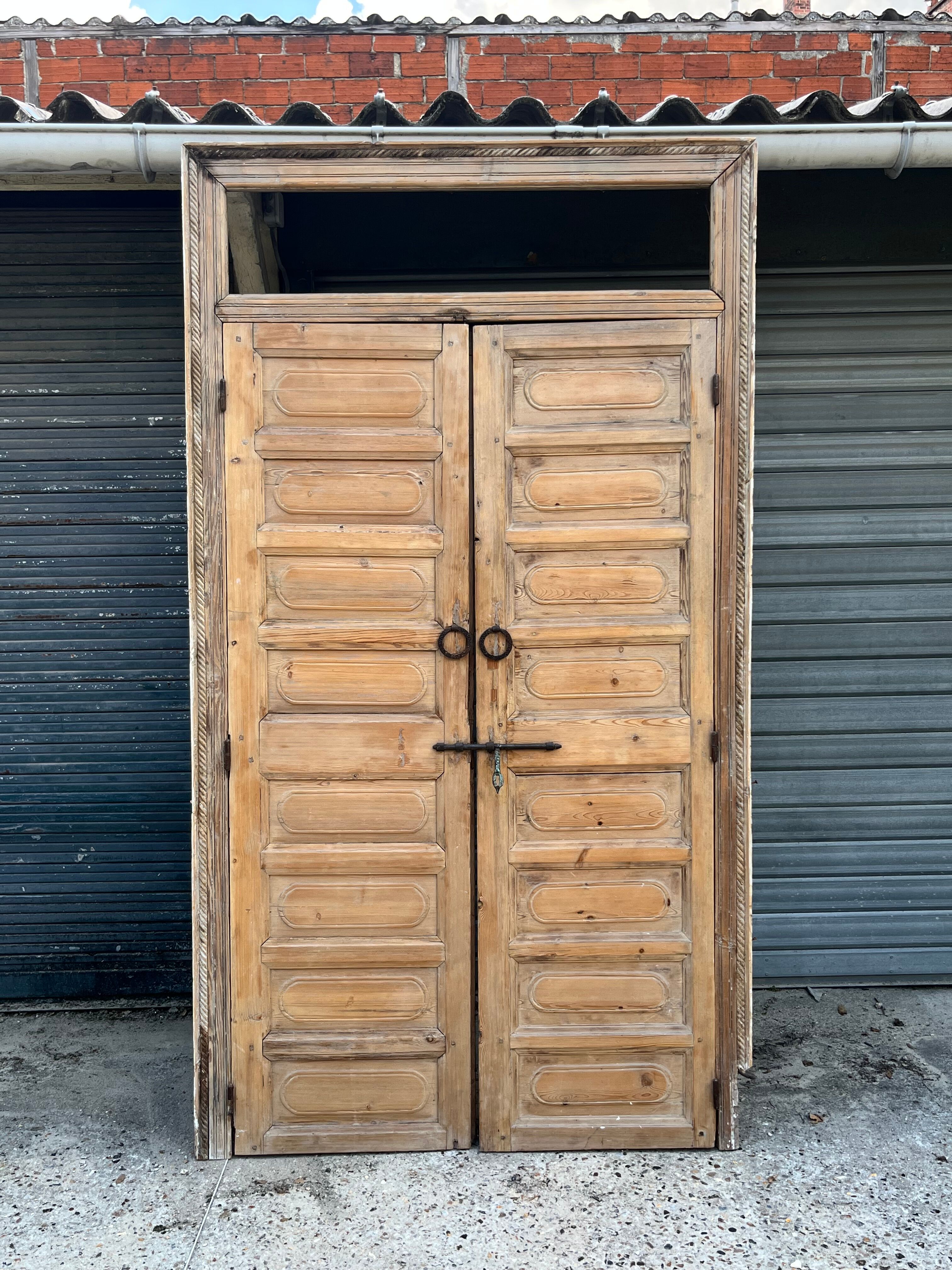 pair of old double-leaf doors with transom and carved frames
