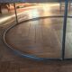 Large round coffee table in wood and wrought iron.