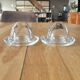 2 egg cups with matching glass cloches in transparent glass