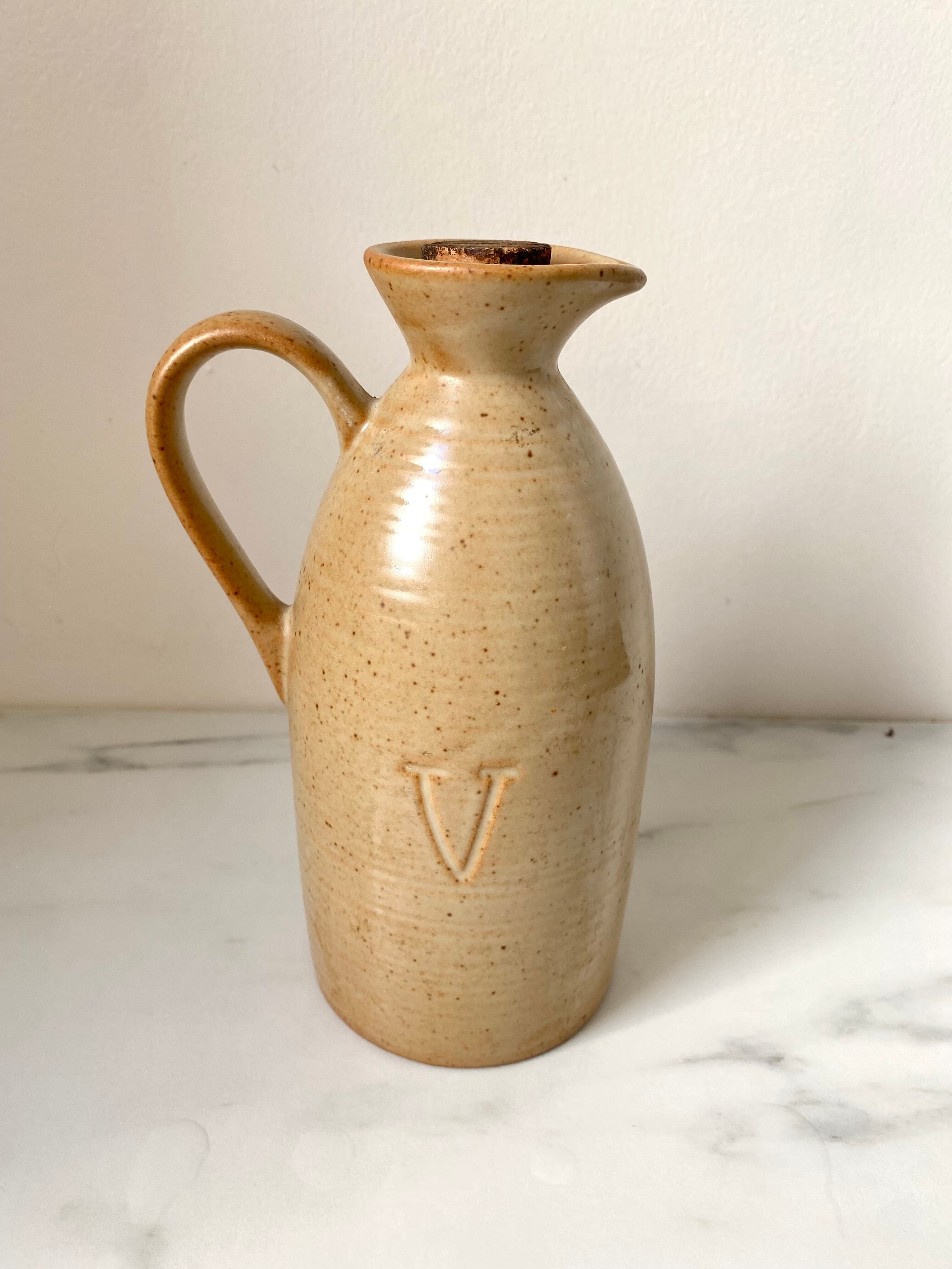 Old vinaigrier in beige sandstone signed Village de France