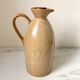 Old vinaigrier in beige sandstone signed Village de France