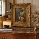Framed reproduction painting with a golden frame.