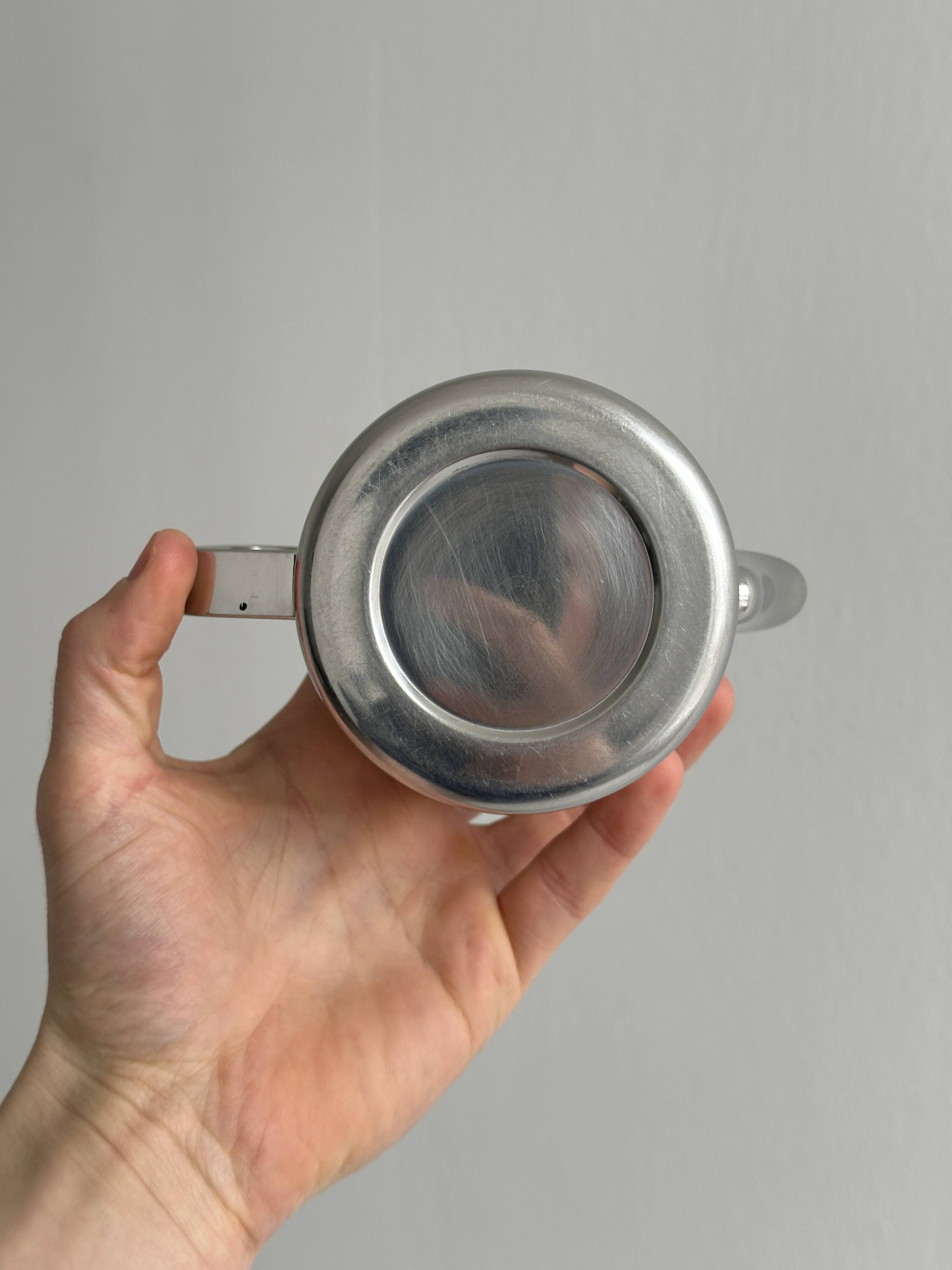 Small shiny stainless steel teapot